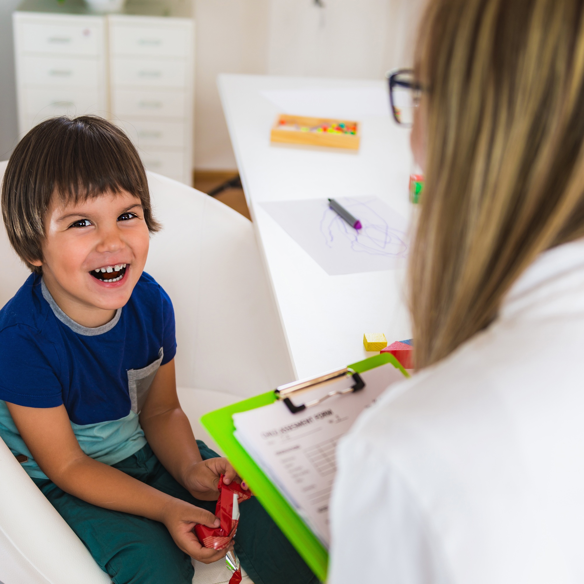 Child psychology, little boy talking to psychologist