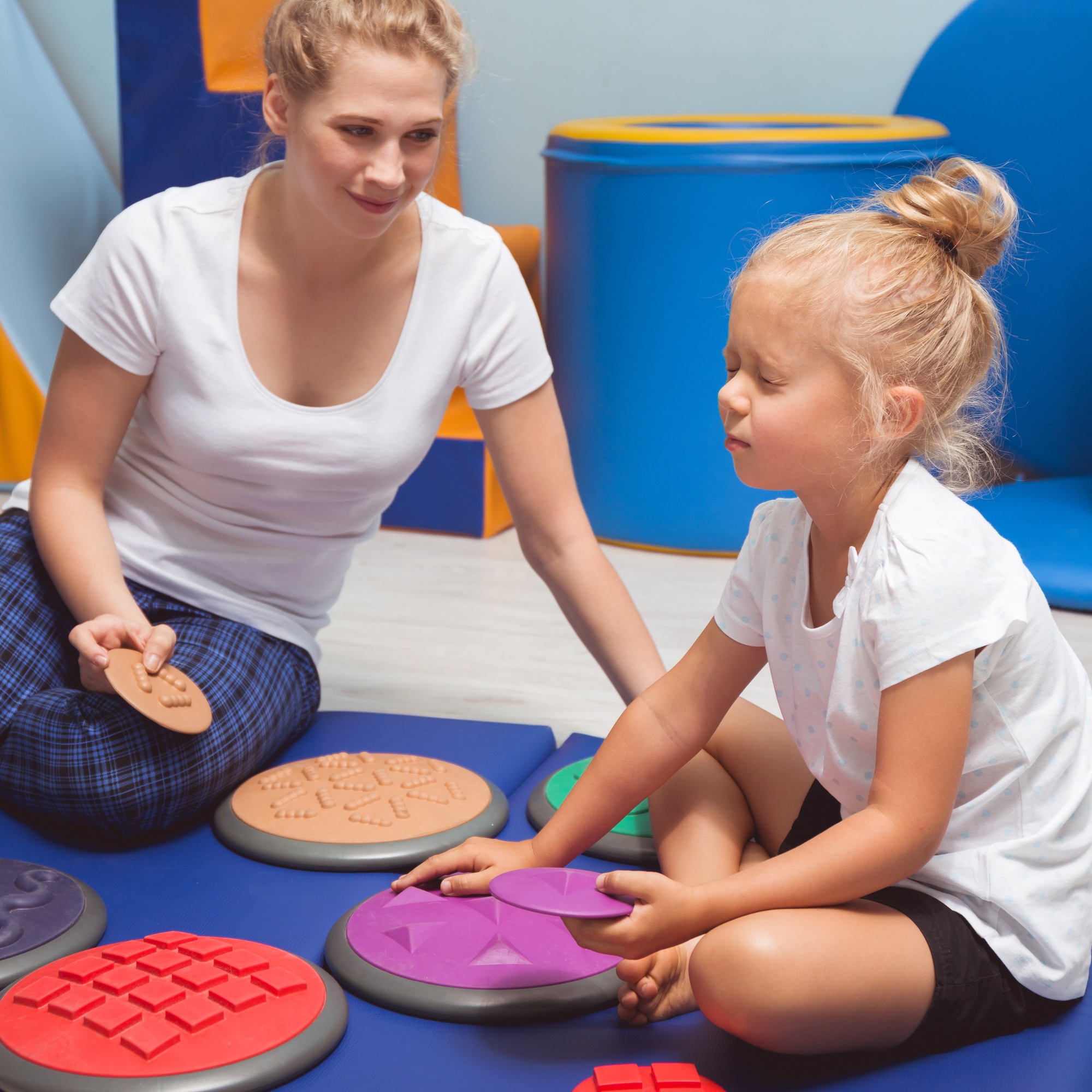 Child touching with closed eyes sensory integration equipment