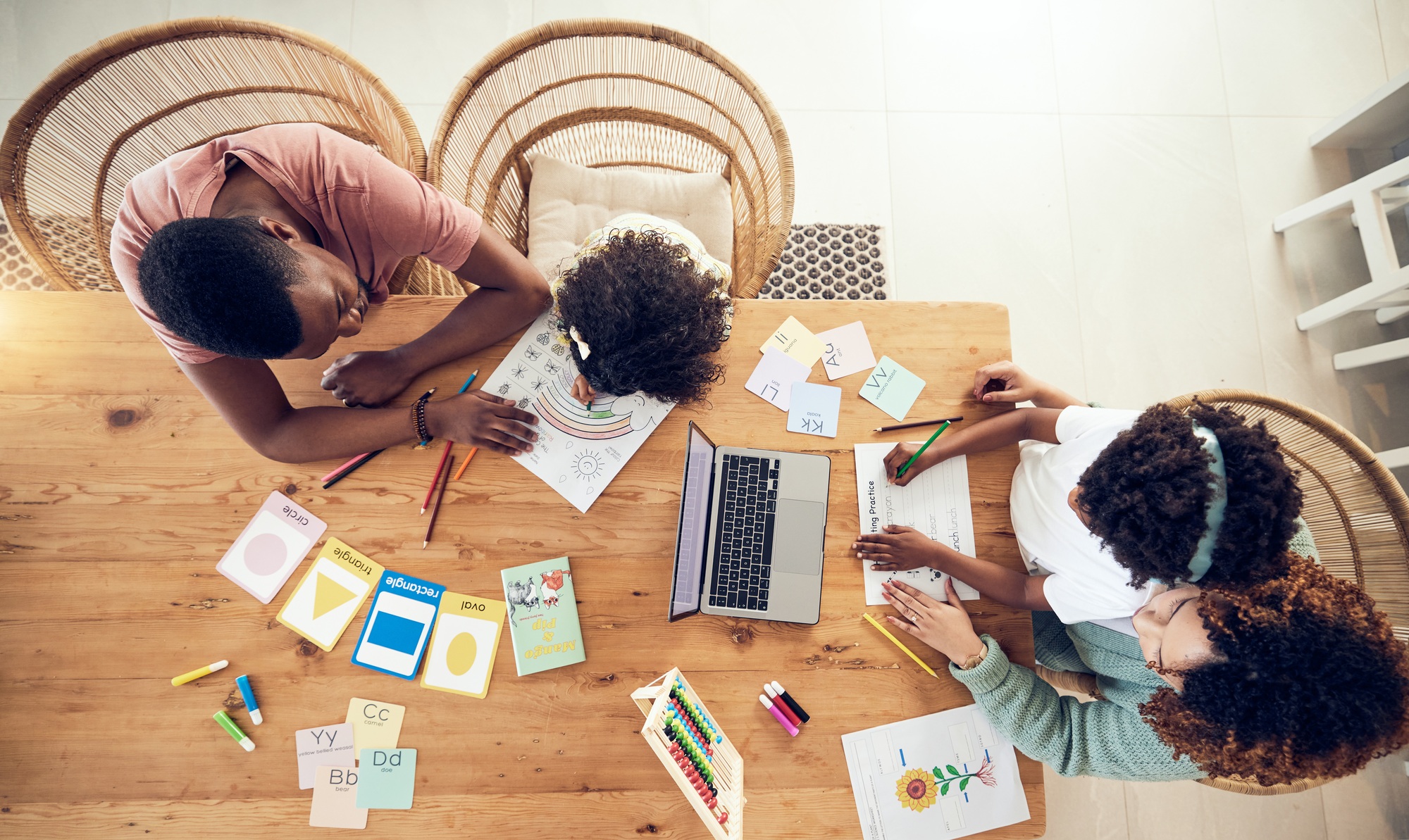 Elearning, eduction and homework with black family at table from top view for creative, care and tu