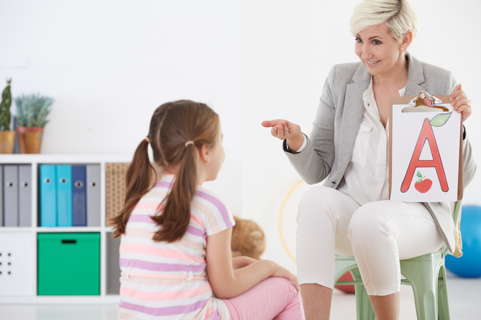 Child and therapist engaging in an ABA session focused on play and communication.